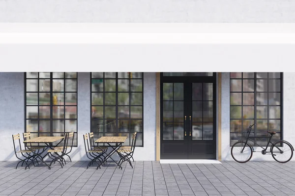 Cafe buitenkant met tabellen en fiets — Stockfoto