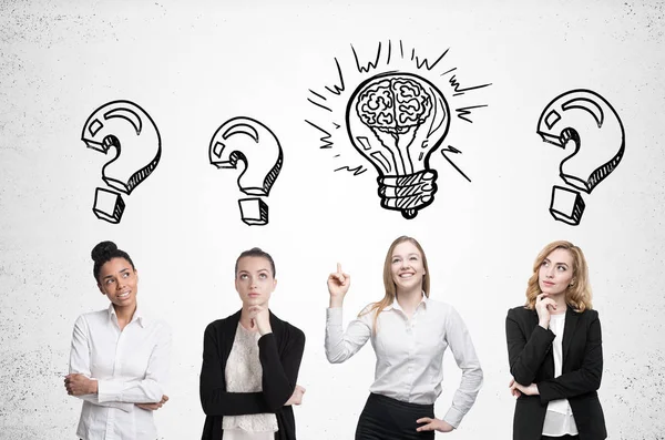 Four women brainstorm. Concrete wall. Sketches — Stock Photo, Image