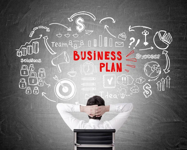 Rear view of man looking at business plan drawing — Stock Photo, Image