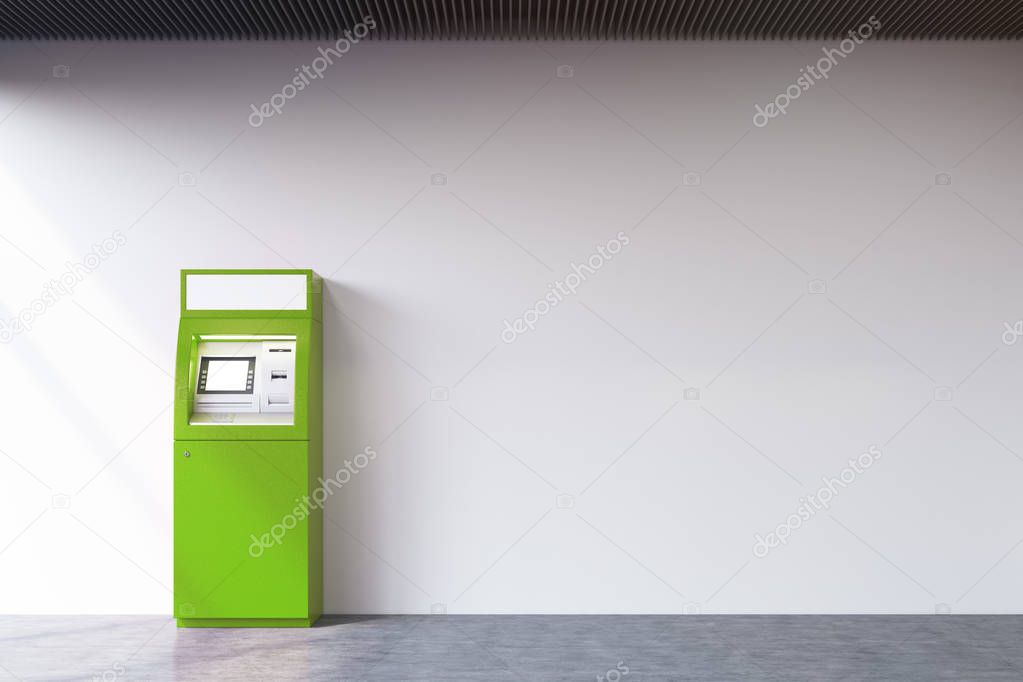 Green ATM machine near concrete wall