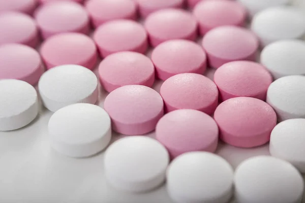 Close up of white and pink pills — Stock Photo, Image