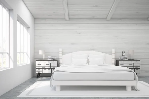 Double bed in a wooden room