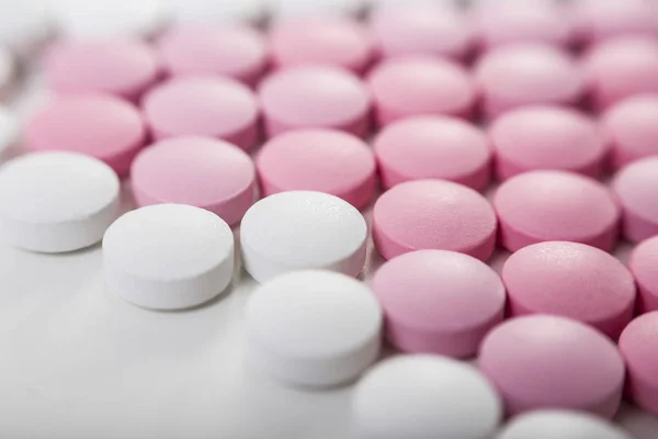 Close up of pink and white pills — Stock Photo, Image