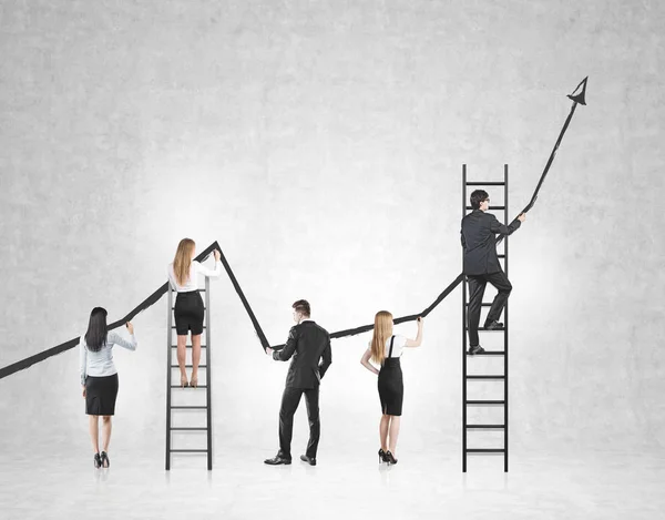 Rear view of a business team drawing a large black growing graph on a concrete wall. Some people are standing on ladders. Mock up. — Stock Photo, Image
