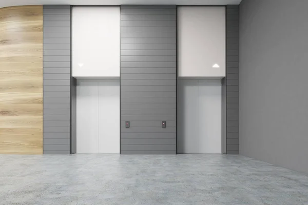 Deux ascenseurs blancs dans le bureau, murs gris — Photo