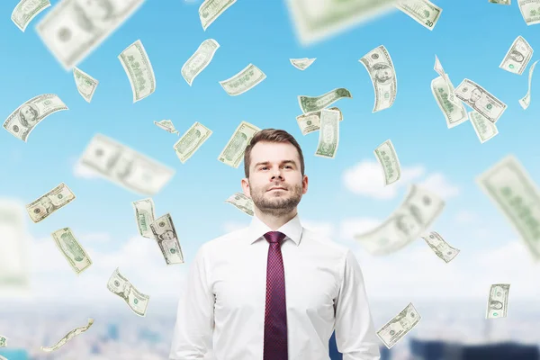 Confident man and a dollar rain in a city — Stock Photo, Image