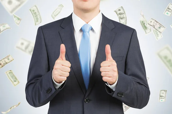 Thumbs up businessman in dollar rain — Stock Photo, Image