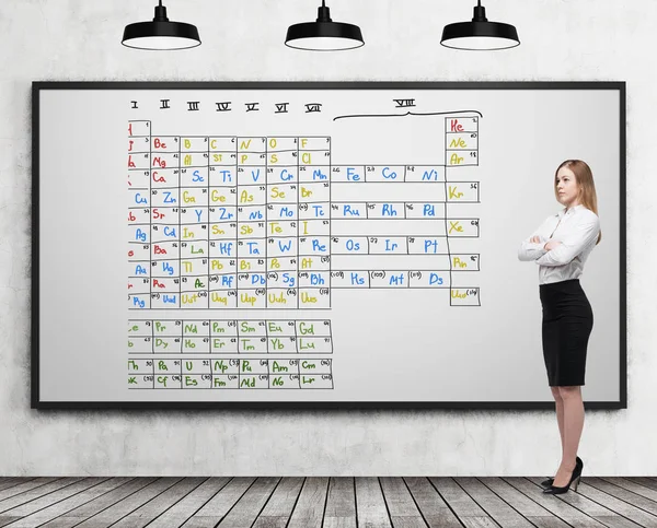 Girl near a whiteboard with Mendeleev table — Stock Photo, Image