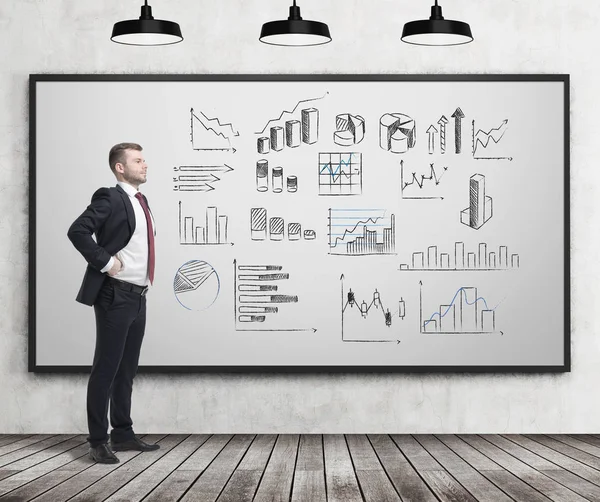 Businessman looking at multiple graphs — Stock Photo, Image