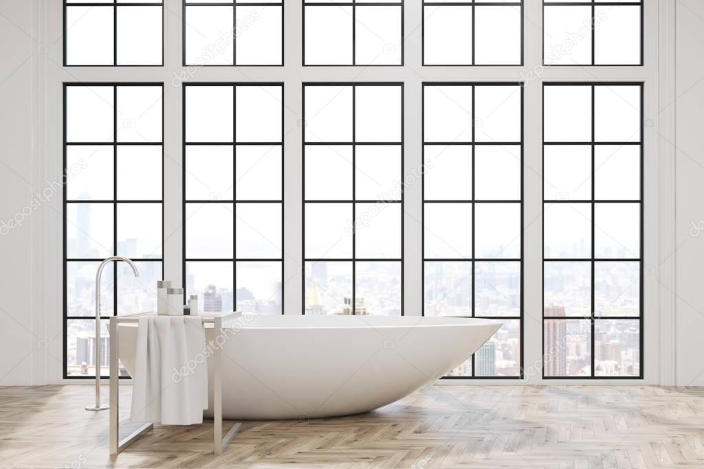 Bathroom with white tub and big windows