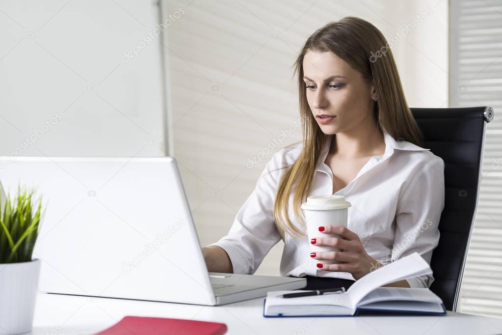 businesswoman with a coffee cup in office