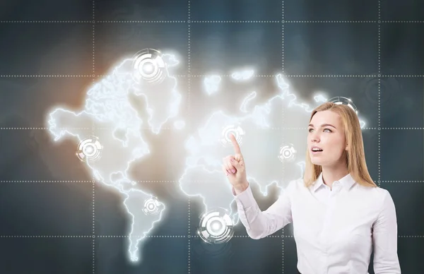 Blond woman interacting with world map — Stock Photo, Image