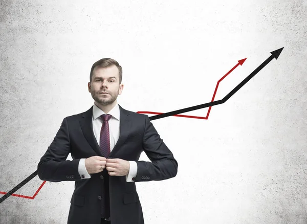 Businessman in suit and red and black graphs — Stock Photo, Image