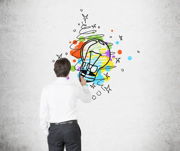 Rear view of man drawing a light bulb — Stock Photo, Image