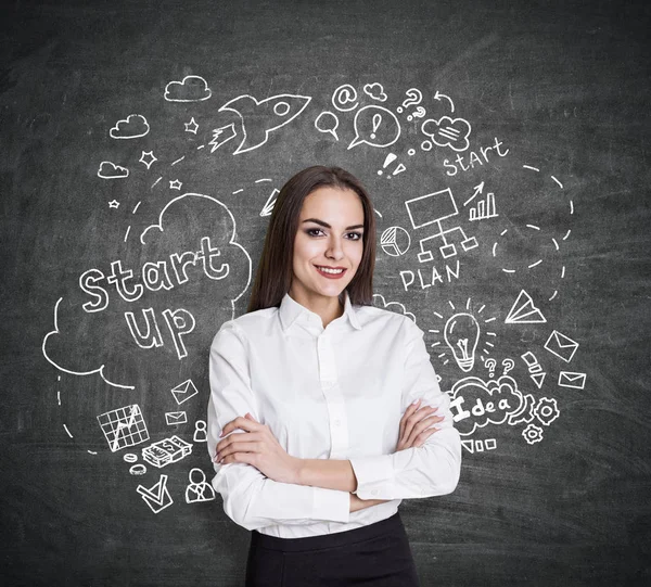 Femme européenne souriante sur fond de tableau noir avec esquisse d'affaires créative. Elle pense aux startups. Concept de réussite — Photo