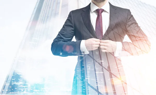 Man buttoning suit and a skyscraper — Stock Photo, Image