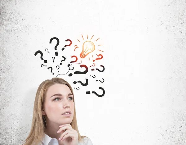 Close up of girl with questions and light bulb — Stock Photo, Image