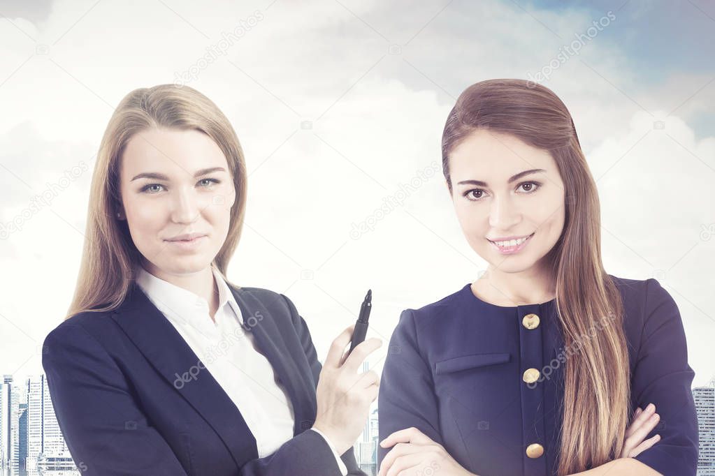 Portrait of two business women in a city