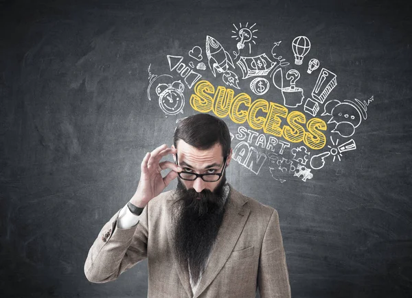 Skeptical man and success icons on blackboard — Stock Photo, Image