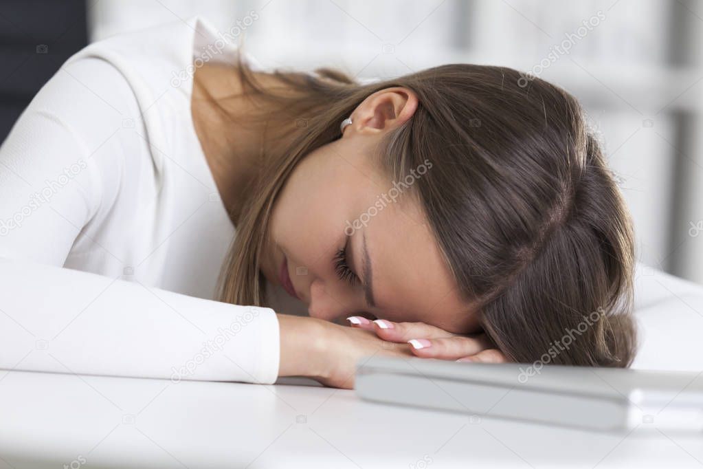 Close up of businesswoman sleeping at work