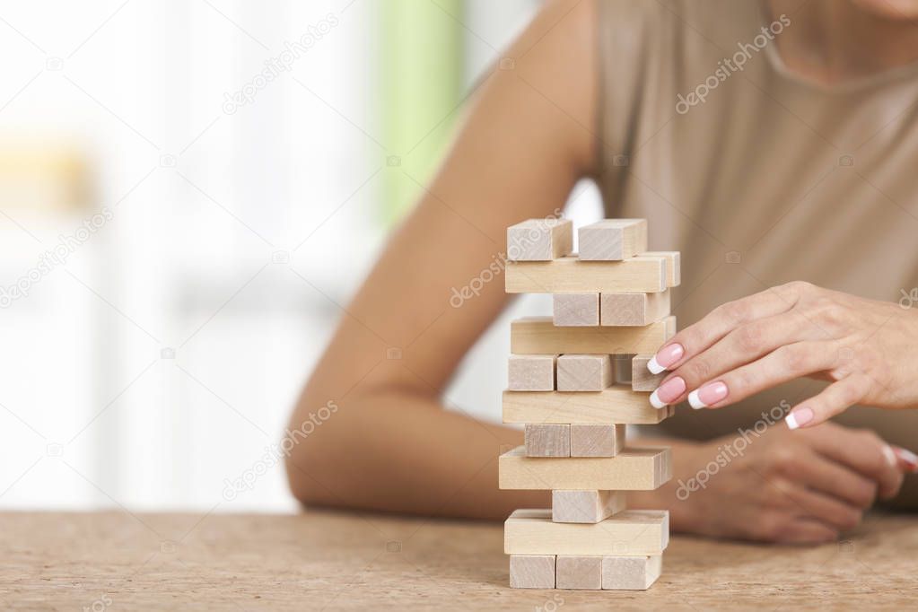 Close up of woman building a tower