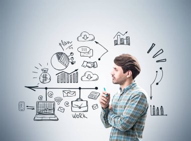 Bir işadamı yakınındaki gri duvar, simgeleri yan görünüm