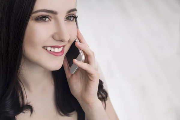 Primer plano de la mujer en beige en el teléfono —  Fotos de Stock