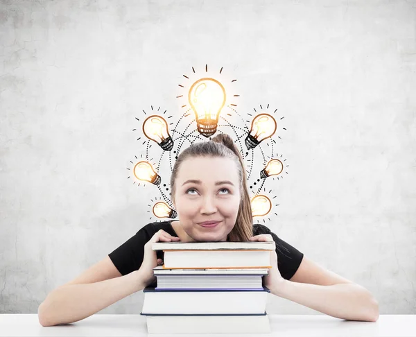 Woman with ponytail, books and seven light bulbs — Stock Photo, Image