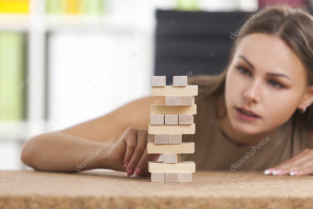 Portrait of businesswoman building a tower