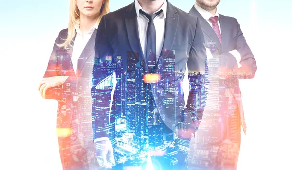 Business trio in a night city — Stock Photo, Image