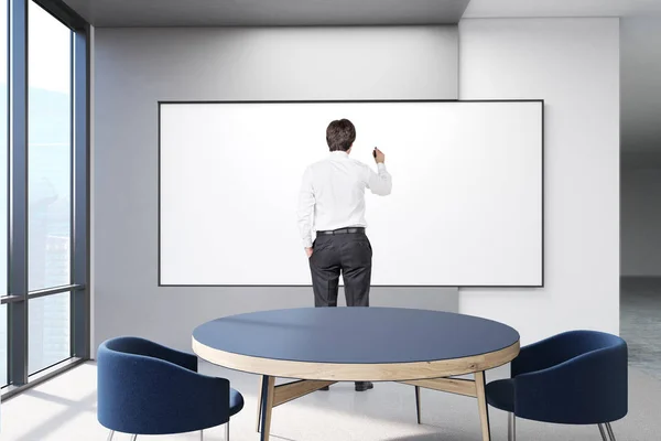 man drawing on blank poster