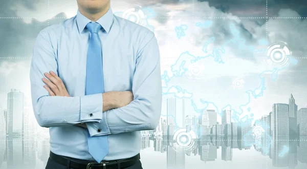 Businessman with crossed arms and gray city — Stock Photo, Image