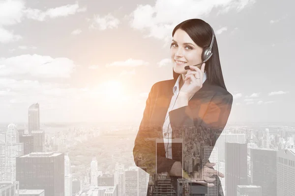 Businesswoman with headset in a city — Stock Photo, Image