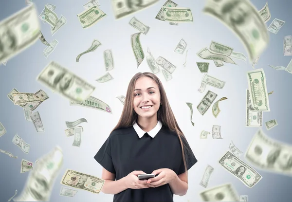 Woman with a smartphone and dollar rain — Stock Photo, Image