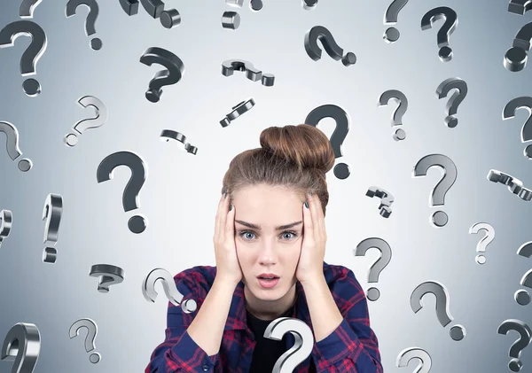 Stressed teen girl and question marks, gray — Stock Photo, Image