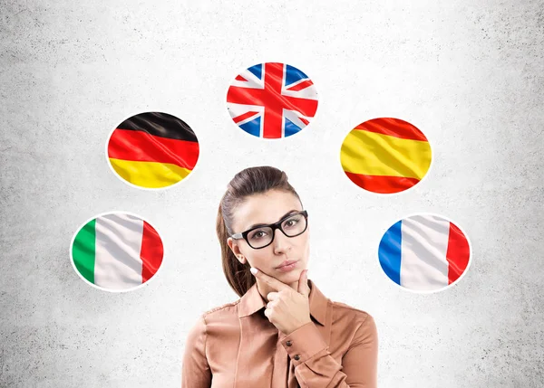 Woman in brown and five flags — Stock Photo, Image