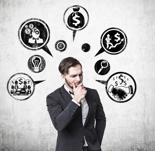 Pensive businessman and money icons — Stock Photo, Image