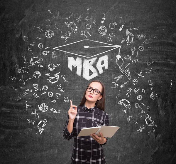 Nerdy girl and an mba sketch on blackboard — Stock Photo, Image
