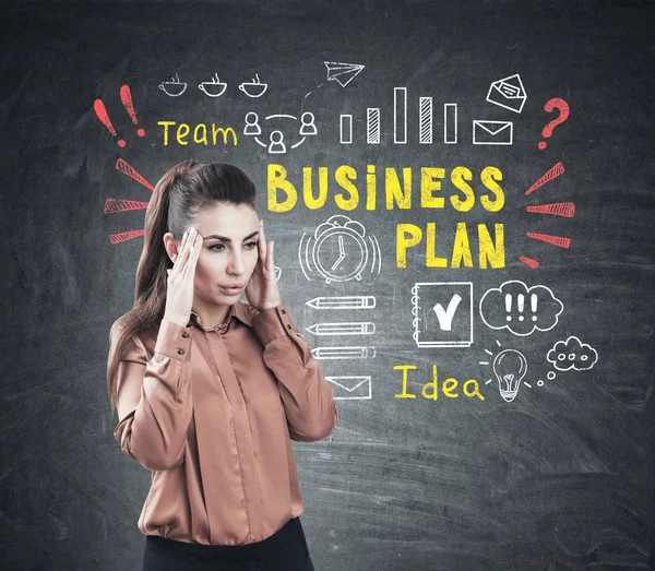 Stressed woman and colorful business plan — Stock Photo, Image