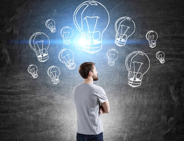 Man in T-shirt and light bulbs — Stock Photo, Image