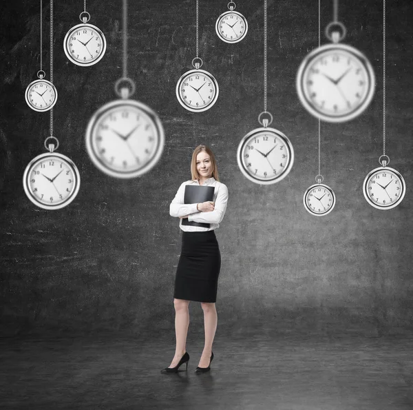 Woman with folder and many clocks — Stock Photo, Image