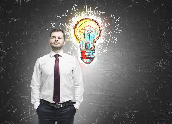 Confident man and colorful light bulb — Stock Photo, Image