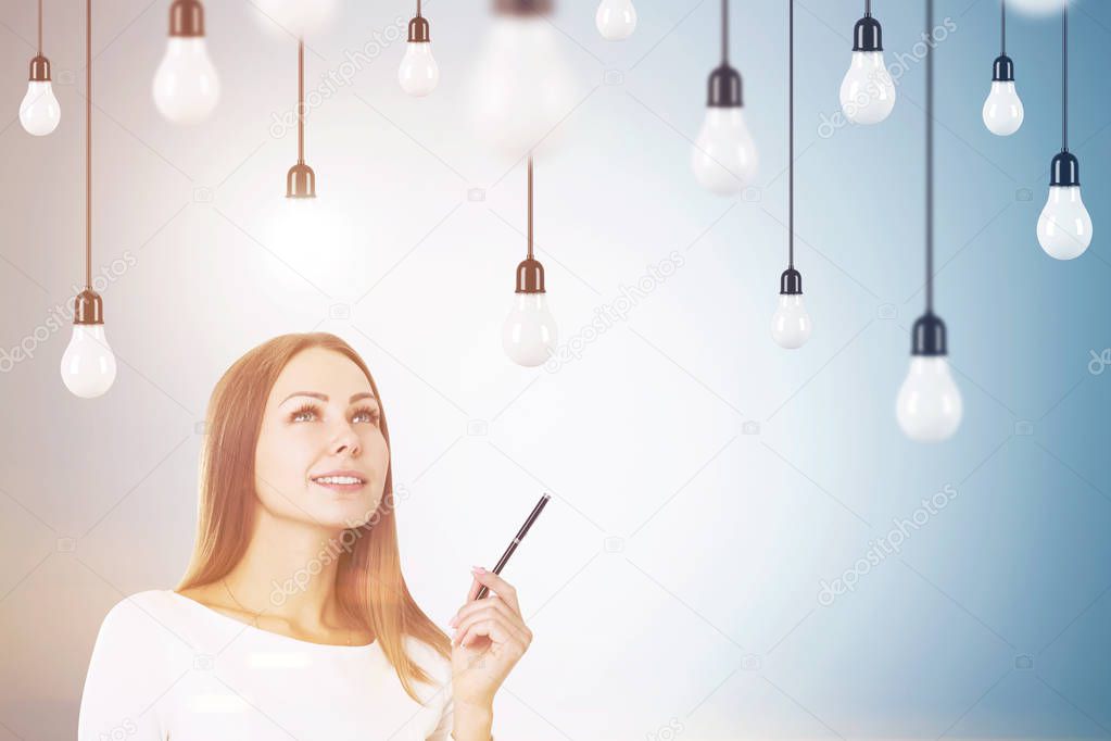 Woman with a pen and light bulbs, toned