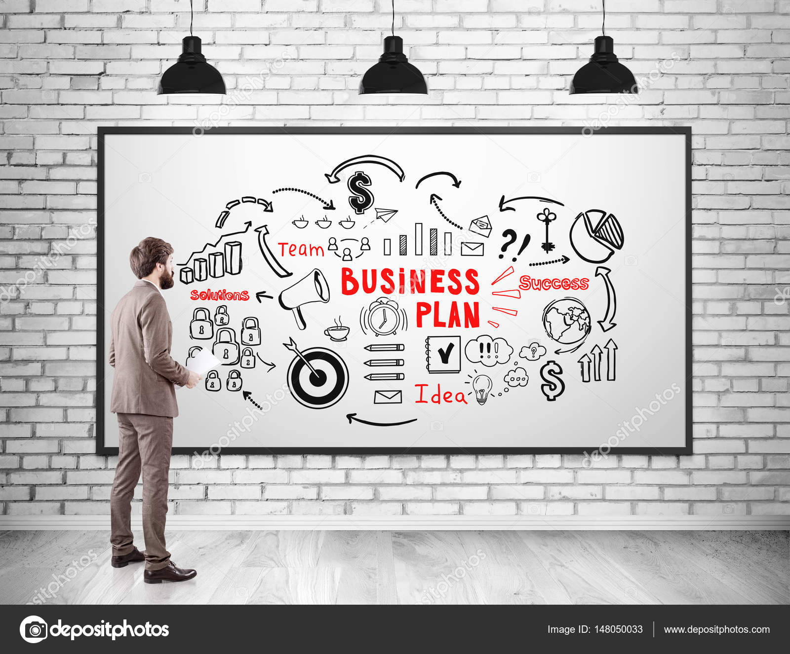 Man With Paper Looking At Business Plan Stock Photo