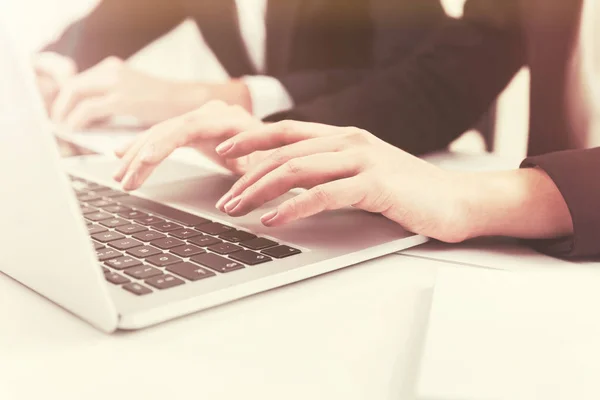 Close up of a woman typing at laptop, toned — Stock Photo, Image