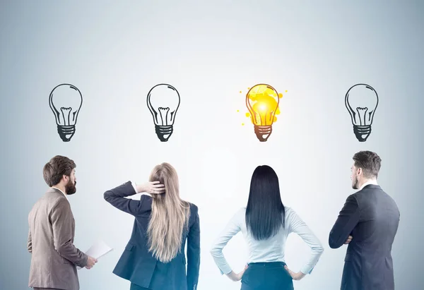 Rear view of men and women with light bulbs, toned — Stock Photo, Image
