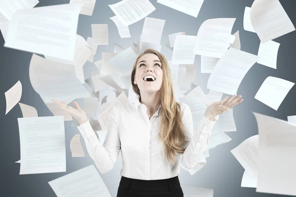 Happy woman throwing papers — Stock Photo, Image
