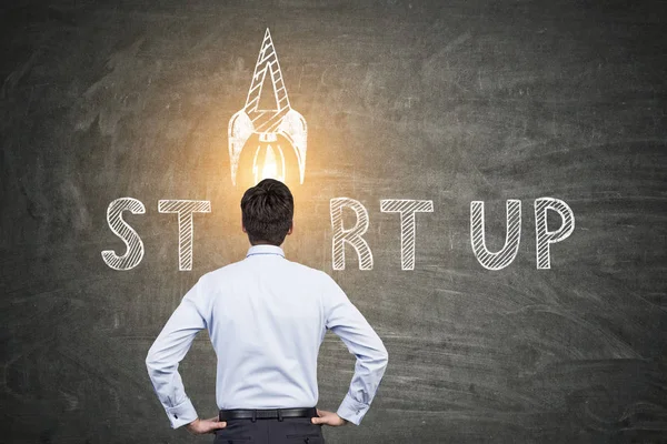 Businessman looking at start up sketch — Stock Photo, Image