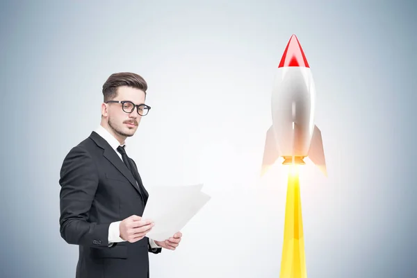 Man with documents and rocket — Stock Photo, Image