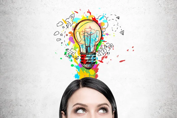 Woman with black hair and colorful light bulb — Stock Photo, Image